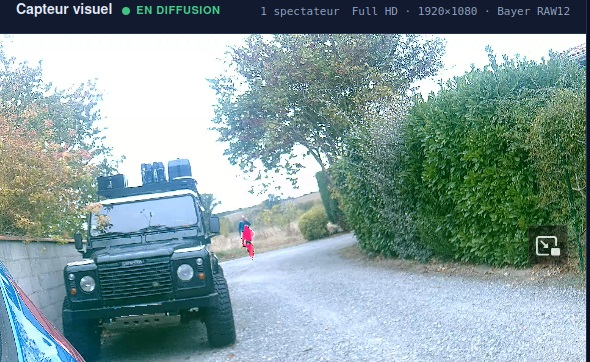 XPLOCAM visible imaging with thermal fusion: thermal information overlaid on a person in a tree-lined courtyard